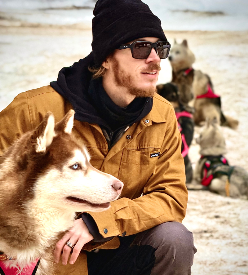 Jay with a huskey in the snow. - StayWild Outdoor